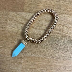 Gold tone stretch braided chain bracelet with faux turquoise crystal pendant